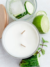 Load image into Gallery viewer, Candle in a glass jar with cucumbers, lime, and mint leaves on a white background
